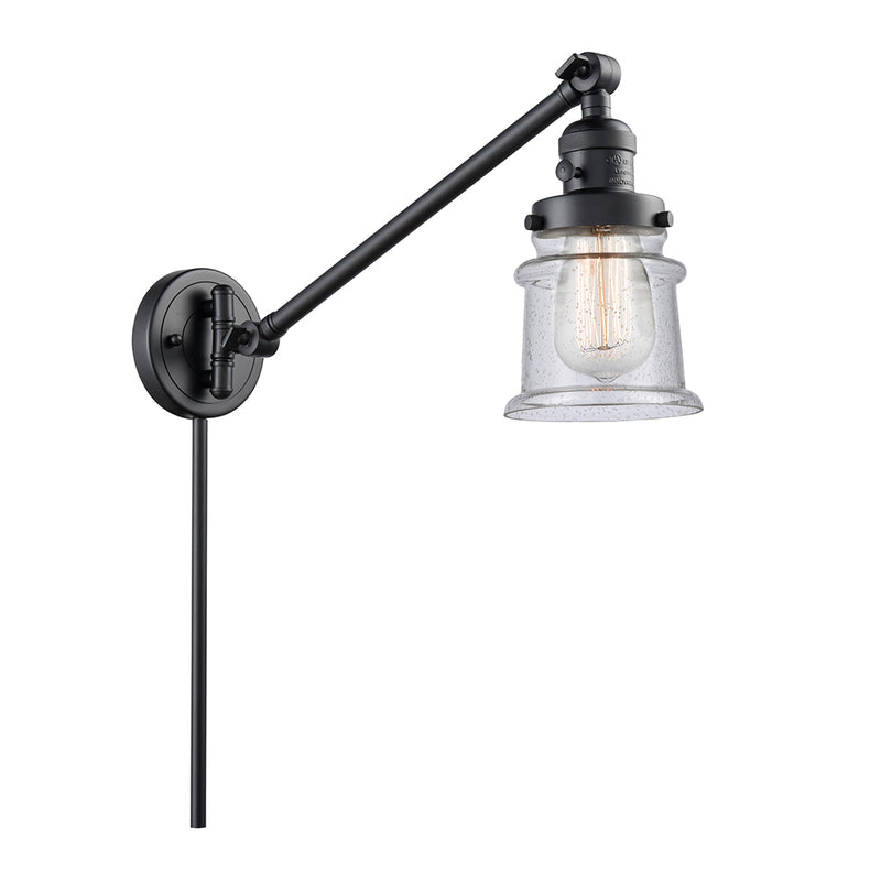 Canton Swing Arm shown in the Matte Black finish with a Seedy shade