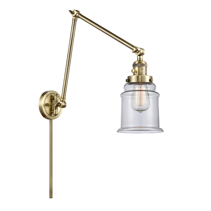 Canton Swing Arm shown in the Antique Brass finish with a Clear shade