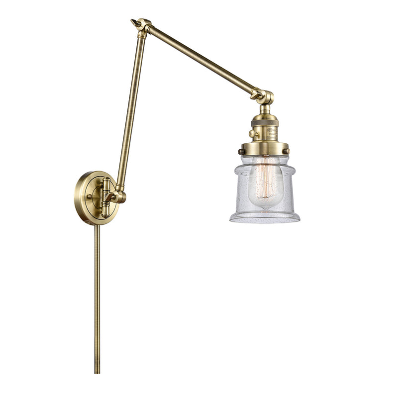 Canton Swing Arm shown in the Antique Brass finish with a Seedy shade