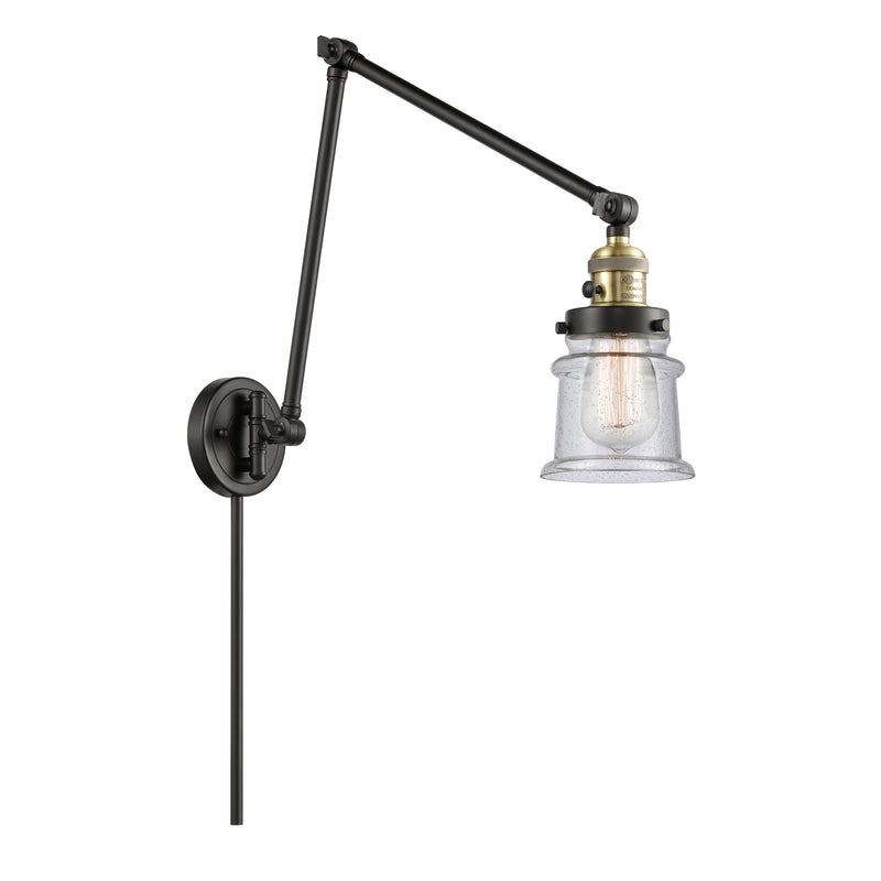 Canton Swing Arm shown in the Black Antique Brass finish with a Seedy shade