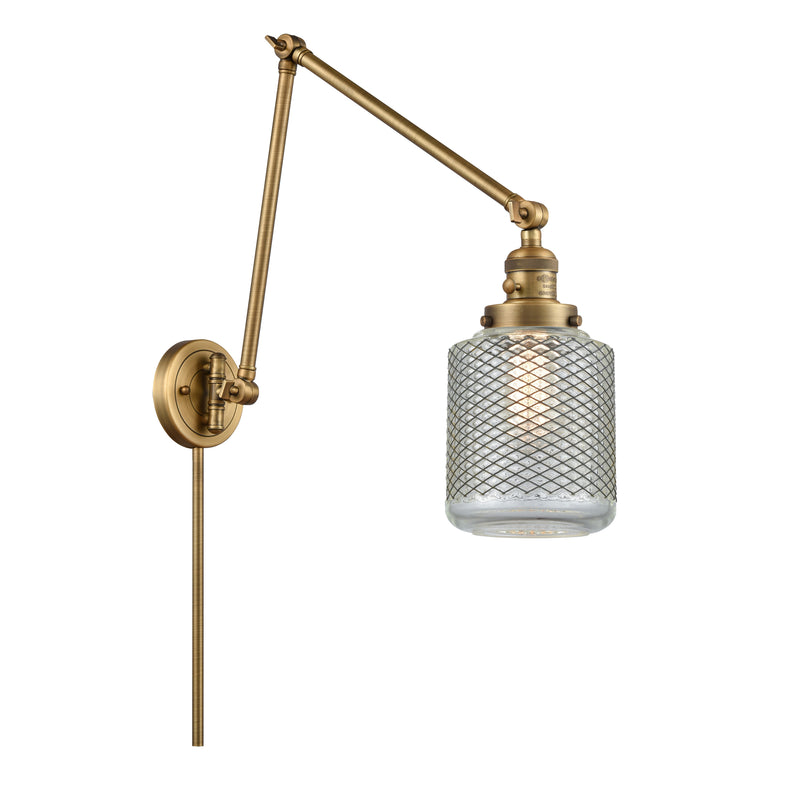 Stanton Swing Arm shown in the Brushed Brass finish with a Clear Wire Mesh shade