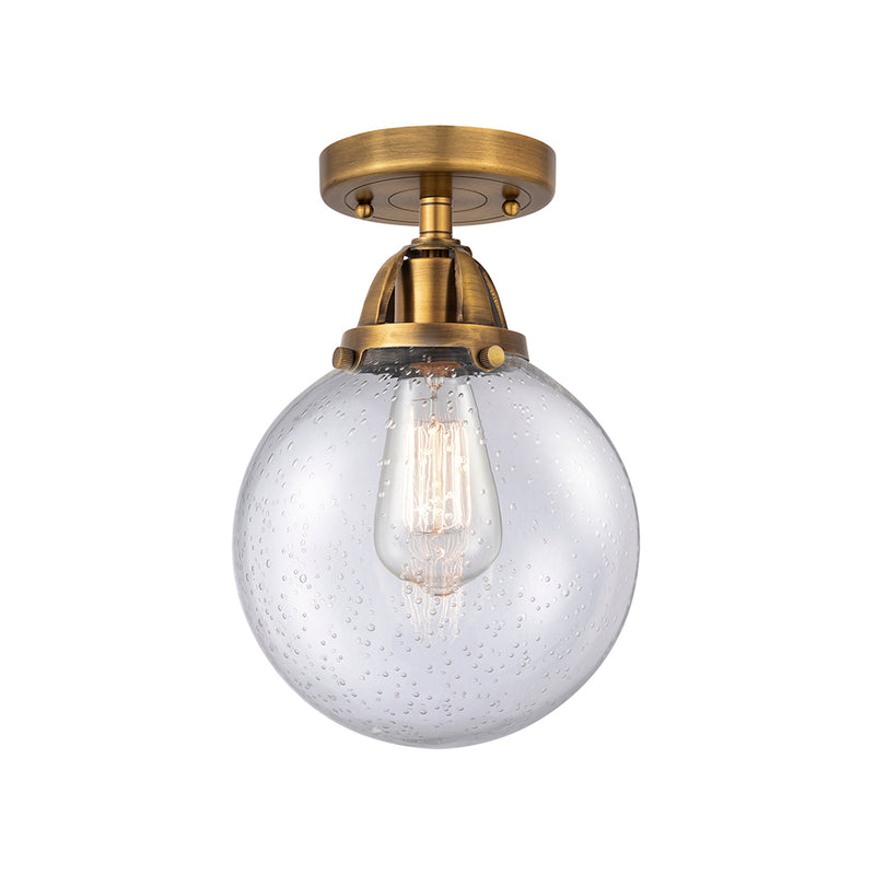 Beacon Semi-Flush Mount shown in the Brushed Brass finish with a Seedy shade