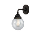 Beacon Sconce shown in the Matte Black finish with a Seedy shade