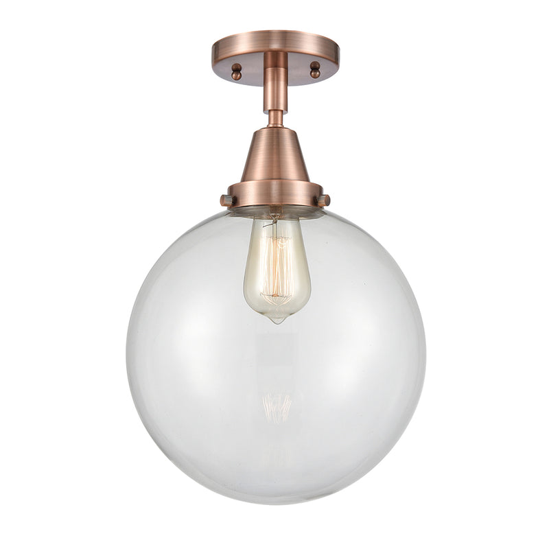 Beacon Flush Mount shown in the Antique Copper finish with a Clear shade