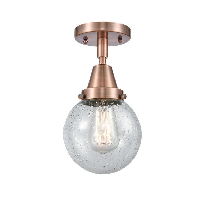 Beacon Flush Mount shown in the Antique Copper finish with a Seedy shade