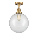 Beacon Flush Mount shown in the Brushed Brass finish with a Clear shade