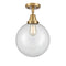 Beacon Flush Mount shown in the Brushed Brass finish with a Clear shade