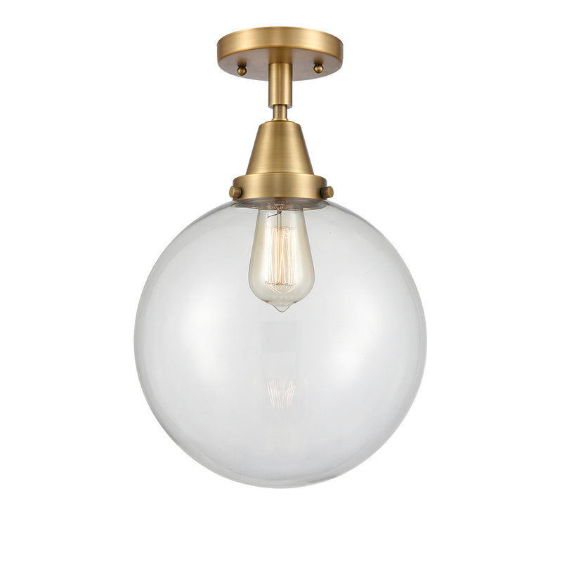 Beacon Flush Mount shown in the Brushed Brass finish with a Clear shade