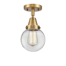 Beacon Flush Mount shown in the Brushed Brass finish with a Clear shade