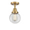 Beacon Flush Mount shown in the Brushed Brass finish with a Clear shade