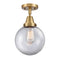 Beacon Flush Mount shown in the Brushed Brass finish with a Clear shade