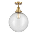 Beacon Flush Mount shown in the Brushed Brass finish with a Seedy shade