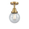 Beacon Flush Mount shown in the Brushed Brass finish with a Seedy shade