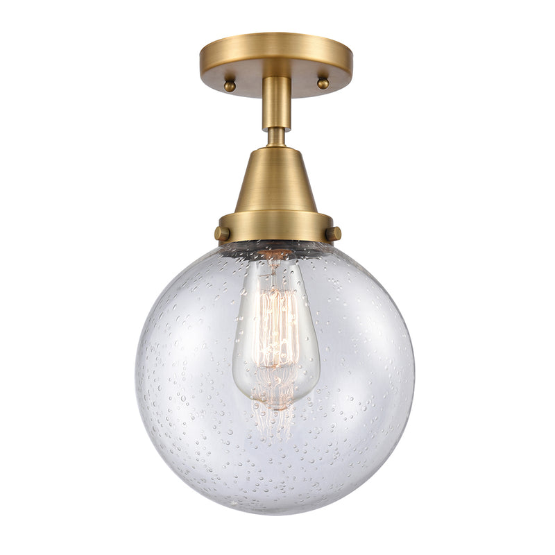 Beacon Flush Mount shown in the Brushed Brass finish with a Seedy shade