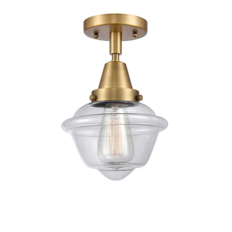 Oxford Flush Mount shown in the Brushed Brass finish with a Clear shade