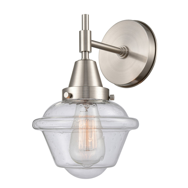 Caden Sconce shown in the Satin Nickel finish with a Seedy shade