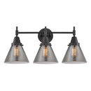 Caden Bath Vanity Light shown in the Matte Black finish with a Plated Smoke shade
