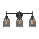 Caden Bath Vanity Light shown in the Matte Black finish with a Plated Smoke shade
