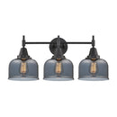 Caden Bath Vanity Light shown in the Matte Black finish with a Plated Smoke shade