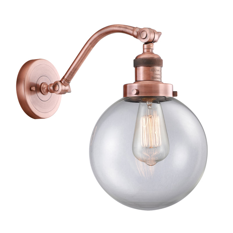 Beacon Sconce shown in the Antique Copper finish with a Clear shade