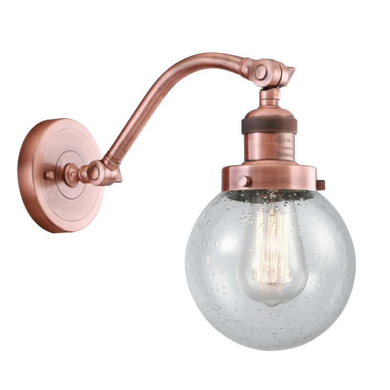 Beacon Sconce shown in the Antique Copper finish with a Seedy shade