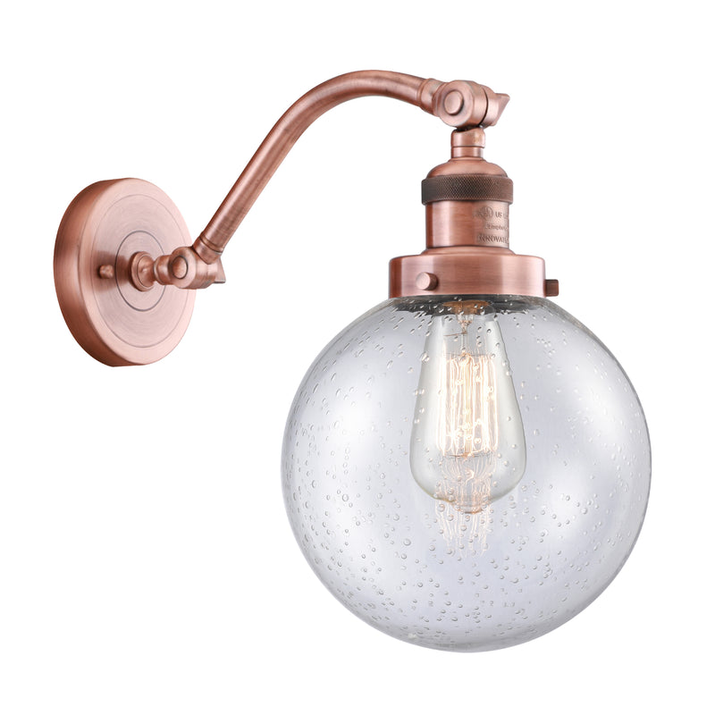 Beacon Sconce shown in the Antique Copper finish with a Seedy shade