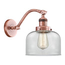 Bell Sconce shown in the Antique Copper finish with a Clear shade