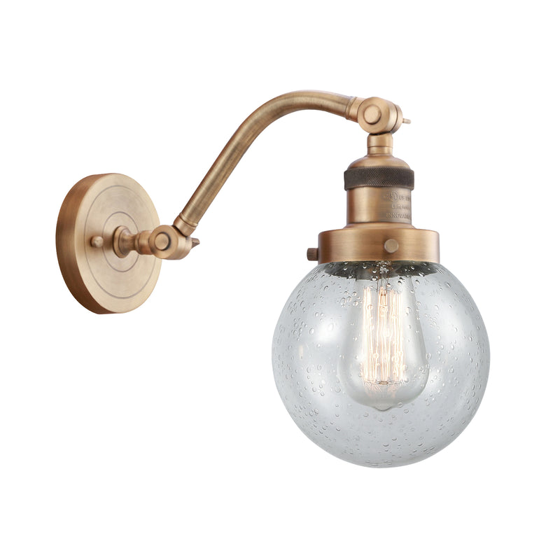 Beacon Sconce shown in the Brushed Brass finish with a Seedy shade