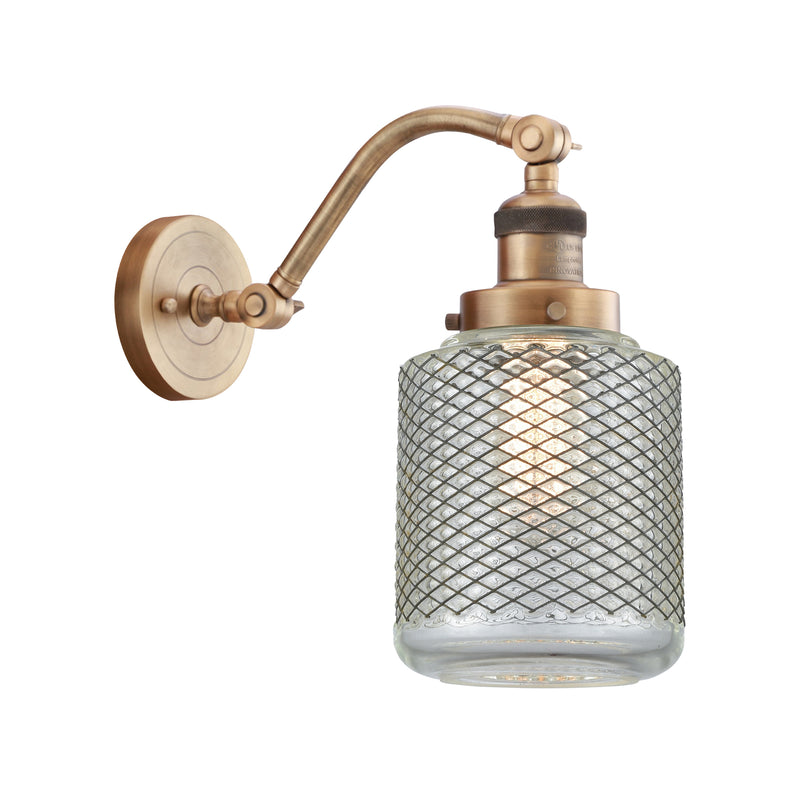 Stanton Sconce shown in the Brushed Brass finish with a Clear Wire Mesh shade