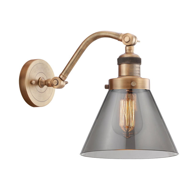 Cone Sconce shown in the Brushed Brass finish with a Plated Smoke shade