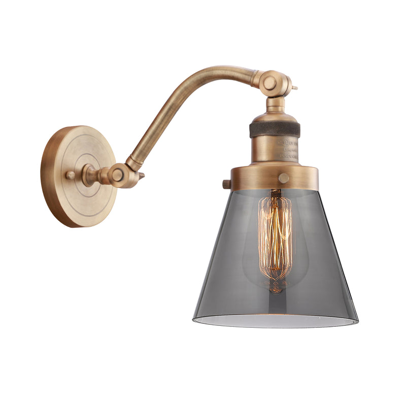 Cone Sconce shown in the Brushed Brass finish with a Plated Smoke shade