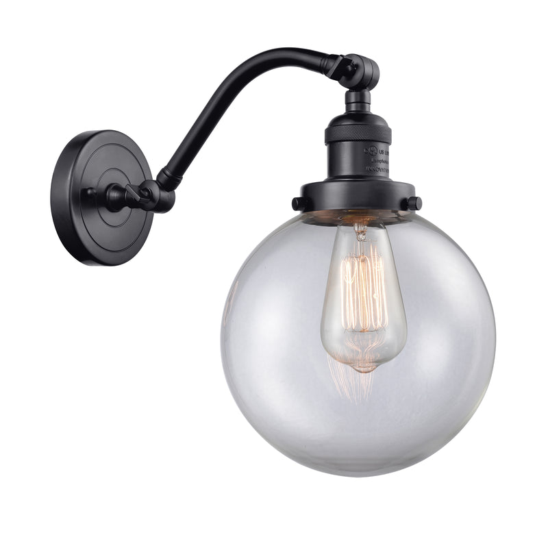 Beacon Sconce shown in the Matte Black finish with a Clear shade