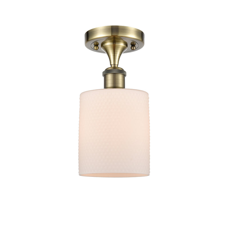 Cobbleskill Semi-Flush Mount shown in the Antique Brass finish with a Matte White shade