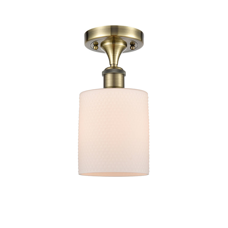 Cobbleskill Semi-Flush Mount shown in the Antique Brass finish with a Matte White shade