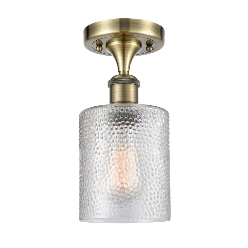 Cobbleskill Semi-Flush Mount shown in the Antique Brass finish with a Clear shade