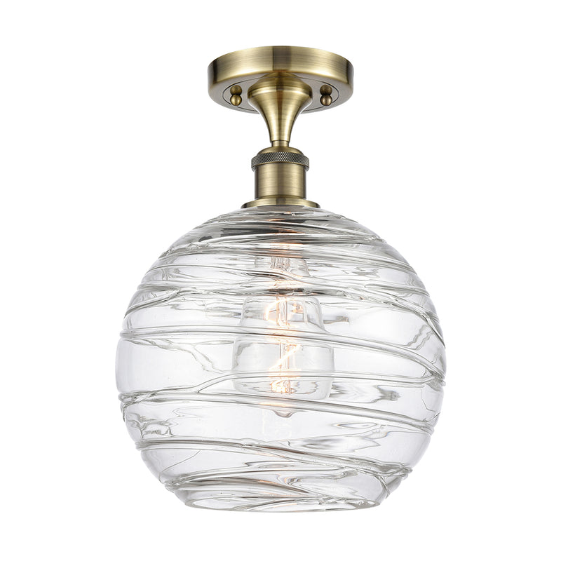 Deco Swirl Semi-Flush Mount shown in the Antique Brass finish with a Clear shade