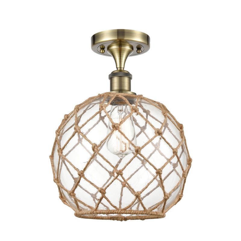 Farmhouse Rope Semi-Flush Mount shown in the Antique Brass finish with a Clear Glass with Brown Rope shade