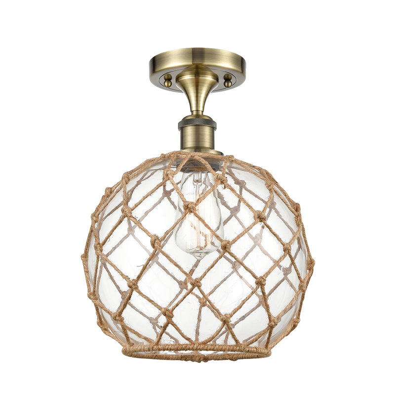 Farmhouse Rope Semi-Flush Mount shown in the Antique Brass finish with a Clear Glass with Brown Rope shade