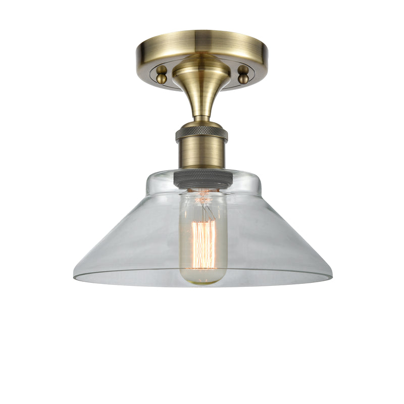 Orwell Semi-Flush Mount shown in the Antique Brass finish with a Clear shade