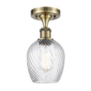 Salina Semi-Flush Mount shown in the Antique Brass finish with a Clear Spiral Fluted shade