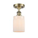 Hadley Semi-Flush Mount shown in the Antique Brass finish with a Matte White shade