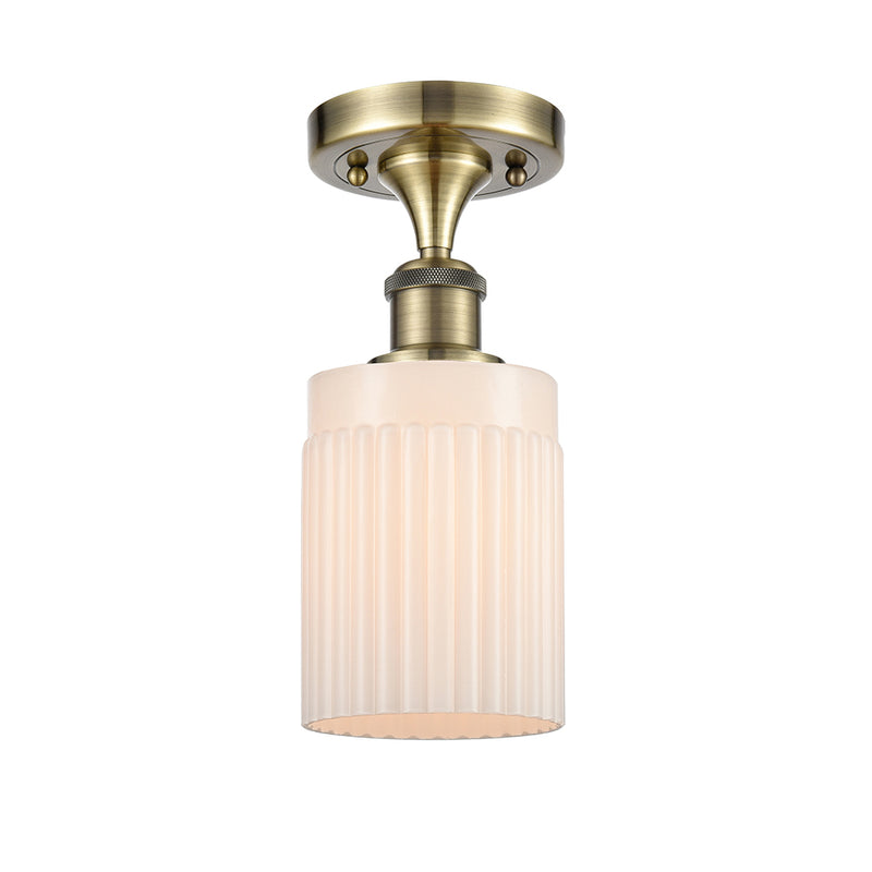 Hadley Semi-Flush Mount shown in the Antique Brass finish with a Matte White shade