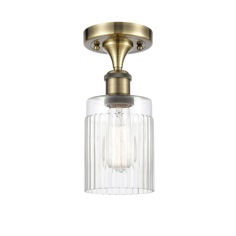 Hadley Semi-Flush Mount shown in the Antique Brass finish with a Clear shade