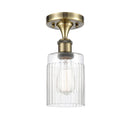Hadley Semi-Flush Mount shown in the Antique Brass finish with a Clear shade