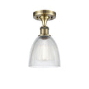 Castile Semi-Flush Mount shown in the Antique Brass finish with a Clear shade