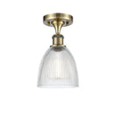 Castile Semi-Flush Mount shown in the Antique Brass finish with a Clear shade