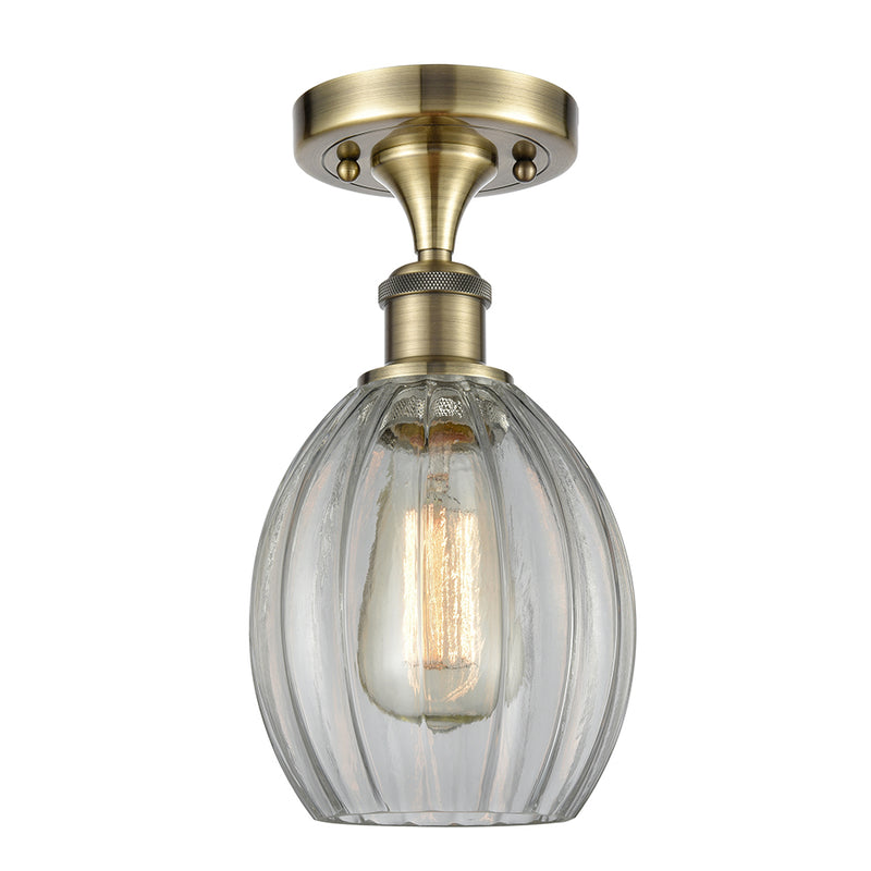 Eaton Semi-Flush Mount shown in the Antique Brass finish with a Clear shade