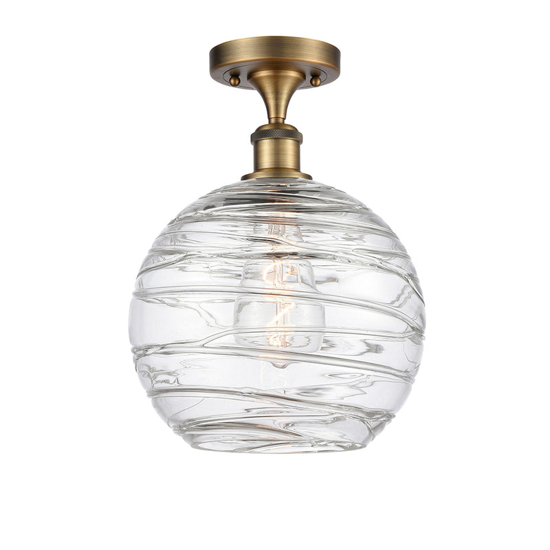 Deco Swirl Semi-Flush Mount shown in the Brushed Brass finish with a Clear shade