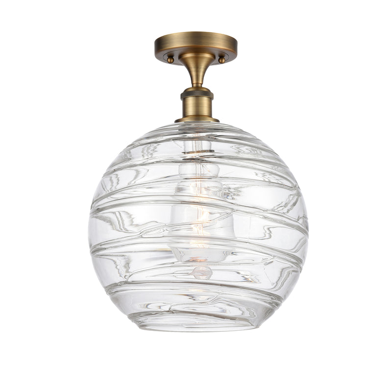 Deco Swirl Semi-Flush Mount shown in the Brushed Brass finish with a Clear shade