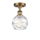 Deco Swirl Semi-Flush Mount shown in the Brushed Brass finish with a Clear shade